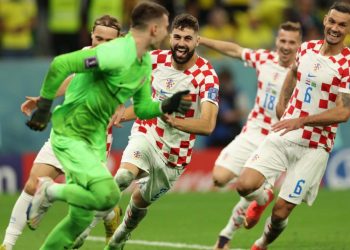 Croatia’s goalkeeper #01 Dominik Livakovic (L) celebrates with teammates after they won on penalty shoot-out the Qatar 2022 World Cup quarter-final football match between Croatia and Brazil at Education City Stadium in Al-Rayyan, west of Doha, on December 9, 2022. (Photo by Adrian DENNIS / AFP)