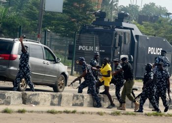 [FILE] Anti-riots policemen detain a protester during a demonstration at Ojota in Lagos on June 12, 2021 (Photo by PIUS UTOMI EKPEI / AFP)