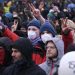 Protesters gesture during a large-scale protest to stop the demolition of the village Luetzerath to make way for an open-air coal mine extension on January 14, 2023. – In an operation launched earlier this week, hundreds of police have been working to remove activists, who have already occupied the hamlet of Luetzerath in western Germany. (Photo by INA FASSBENDER / AFP)