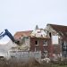 A building is demolished in the village of Luetzerath, western Germany, to make way for an open-air coal mine extension on January 16, 2023. – In an operation launched earlier this week, hundreds of police have been working to remove activists, who have already occupied the hamlet of Luetzerath in western Germany. (Photo by INA FASSBENDER / AFP)