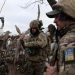 Ukrainian servicemen examine an RPG rocket as they stand in a trench on a frontline position in the Donetsk region on January 23, 2023, amid the Russian invasion of Ukraine. (Photo by Anatolii Stepanov / AFP)