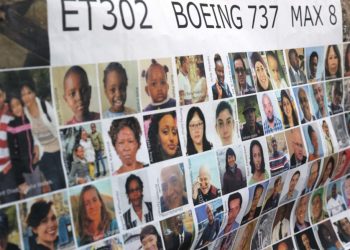 Relatives of victims hold a placard with the victims of Ethiopia flight 302 the US Courthouse before Boeing is to be arraigned on federal crime charges at the in Fort Worth, Texas, on January 26, 2023. – Boeing is set to be arraigned on felony charges after the families of the victims of two separate crashes of 737 Max jets in 2018 and 2019 claimed that the government has violated their rights by reaching a settlement with Boeing without notifying them first. (Photo by Shelby Tauber / AFP)