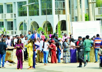 Residents of Federal Capital Territory (FCT) in a queue to collect their PVCs at INEC office in Abuja… . PHOTO: LUCY LADIDI ATEKO