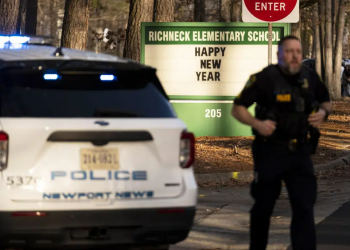 A police officer runs in front of a police patrol car at Richneck Elementary School, Newport News, Virginia. Photo: Sunday World