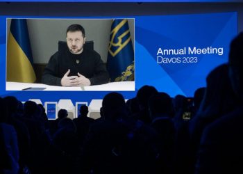 Ukrainian President Volodymyr Zelensky is displayed on a screen via video link at the Congress centre during the World Economic Forum (WEF) annual meeting in Davos January 18, 2023. (Photo by Fabrice COFFRINI / AFP)