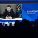 Ukrainian President Volodymyr Zelensky is displayed on a screen via video link at the Congress centre during the World Economic Forum (WEF) annual meeting in Davos January 18, 2023. (Photo by Fabrice COFFRINI / AFP)