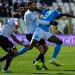 Napoli’s Nigerian forward Victor Osimhen challenges Spezia’s Italian midfielder Salvatore Esposito (L) and Spezia’s French Moroccan midfielder Mehdi Bourabia during the Italian Serie A football match between Spezia and Napoli on February 5, 2023 at the Alberto-Picco stadium in La Spezia. (Photo by Alberto PIZZOLI / AFP)