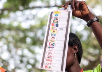 An Independent National Electoral Commission (INEC) official holds up a ballot paper during the counting process at a polling station in Ibadan on February 25, 2023, during Nigeria’s presidential and general election. (Photo by Samuel Alabi / AFP)