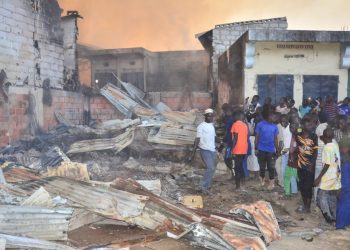 People assess the damage after a fire broke out at the Maiduguri Monday Market in Maiduguri on February 26, 2023. (Photo by Audu MARTE / AFP)