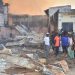 People assess the damage after a fire broke out at the Maiduguri Monday Market in Maiduguri on February 26, 2023. (Photo by Audu MARTE / AFP)