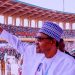 President Muhammadu Buhari acknowledge cheers from supporters.