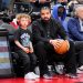 Drake sits with his son Adonis before the Toronto Raptors play the Philadelphia 76ers in their basketball game at the Scotiabank Arena on April 7, 2022 in Toronto, Ontario, Canada. (Photo by Mark Blinch/Getty Images)