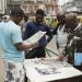 People read newspapers at Tinubu Market in Lagos on February 19, 2023, ahead of the Nigerian presidential election scheduled for February 25, 2023. (Photo by Patrick Meinhardt / AFP)