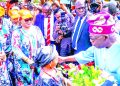 Presidential candidate of All Progressives Congress (APC), Bola Tinubu (right) receiving a bouquet from a girl during the party’s campaign rally, in Osogbo, Osun State…yesterday.