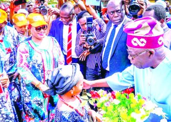 Presidential candidate of All Progressives Congress (APC), Bola Tinubu (right) receiving a bouquet from a girl during the party’s campaign rally, in Osogbo, Osun State…yesterday.