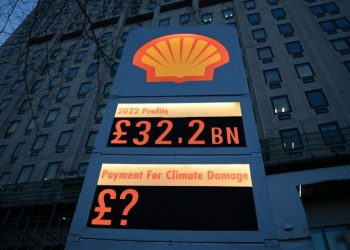 Activists from Greenpeace set up a mock-petrol station price board displaying the Shell’s net profit for 2022, as they demonstrate outside the company’s headquarters in London on February 2, 2023, as the British energy company announce their full-year results. – Shell net profit surged to a record $42.3 billion last year, the British energy giant said Thursday, as Russia’s invasion of Ukraine sent oil and gas prices soaring. The post-tax figure was more than double the amount achieved in 2021, the group’s earnings statement revealed. (Photo by Daniel LEAL / AFP)