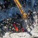 An aerial picture shows rescuers searching the rubble of buildings for casualties and survivors in the village of Salqin in Syria’s rebel-held northwestern Idlib province at the border with Turkey following an earthquake, on February 7, 2023. (Photo by Omar HAJ KADOUR / AFP)