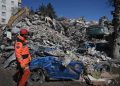 [file] A rescuer stands in front of rubble near the site where Aleyna Olmez, 17, was rescued from a collapsed building, 248 hours after the 7.8-magnitude earthquake which struck parts of Turkey and Syria, in Kahramanmaras on February 16, 2023. (Photo by OZAN KOSE / AFP)