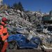 [file] A rescuer stands in front of rubble near the site where Aleyna Olmez, 17, was rescued from a collapsed building, 248 hours after the 7.8-magnitude earthquake which struck parts of Turkey and Syria, in Kahramanmaras on February 16, 2023. (Photo by OZAN KOSE / AFP)