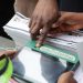 A voter’s identity is confirmed by fingerprint on a Bimodal Voter Accreditation System (BVAS) at a polling station in Ibadan on February 25, 2023, during Nigeria’s presidential and general election. (Photo by Samuel Alabi / AFP)