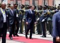 Angola’s President Joao Lourenco (2nd R) and French President Emmanuel Macron (C) inspect the guard of honour during the welcome ceremony at Casa Rosada Presidential Palace in Luanda on March 3, 2023. – Macron arrived in the former Portuguese colony of Angola on March 3, where he is set to sign an accord to develop the agricultural sector as part of a drive to enhance French ties with anglophone and Portuguese-speaking Africa. (Photo by LUDOVIC MARIN / POOL / AFP)