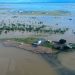 This handout photo taken on March 10, 2023 and received on March 11, 2023 from the Queensland Police Service shows an aerial view of the flooded northern Queensland town of Burketown. – Police urged all residents of the remote Australian town to evacuate on March 11, 2023, warning that record-high floodwaters were expected to rise further over the weekend. (Photo by Handout / QUEENSLAND POLICE SERVICE / AFP) /