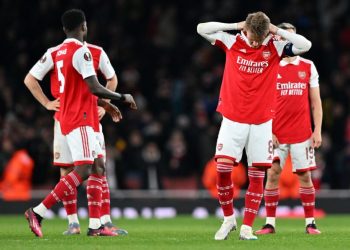 Arsenal’s Norwegian midfielder Martin Odegaard (2R) and teammates react after a penalty shoot-out in the UEFA Europa League round of 16, second-leg football match between Arsenal and Sporting Lisbon at the Emirates Stadium in London on March 16, 2023. – Sporting Lisbon won the match 5-3 on penalties. (Photo by Glyn KIRK / AFP)