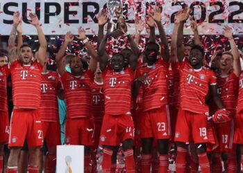 Bayern Munich’s Senegalese forward Sadio Mane lifts the trophy after the German Supercup