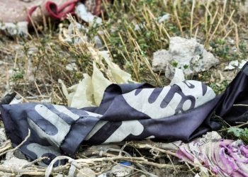 A discarded Islamic State flag lies torn on the ground (Giuseppe Cacace/AFP/Getty Images)