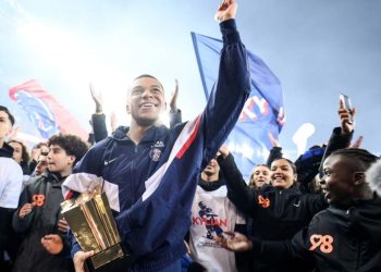 Paris Saint-Germain’s French forward Kylian Mbappe cheer supporters at the end of a ceremony after he became Paris Saint-Germain’s all-time top scorer with his 201st goal for the club in their 4-2 win in the French L1 football match against FC Nantes at The Parc des Princes Stadium in Paris on March 4, 2023. (Photo by FRANCK FIFE / POOL / AFP)