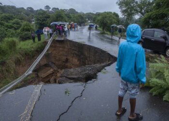 (FILES) In this file photo taken on March 13, 2023, a view of a collapsed road caused by flooding waters due to heavy rains following cyclone Freddy in Blantyre, Malawi. – Cyclone Freddy’s extraordinary journey will be revisited in minute detail to verify whether its deadly track should count as the longest-lasting tropical storm, the world extreme weather records chief told AFP. The cyclone crossed the entire southern Indian Ocean to wreak death and destruction on southeast Africa in February and March. (Photo by Amos Gumulira / AFP)