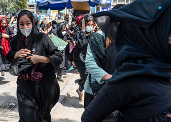 In this file photo, Taliban fighters fire in air to disperse Afghan women protesters in Kabul on August 13, 2022. (Photo by Wakil KOHSAR / AFP)