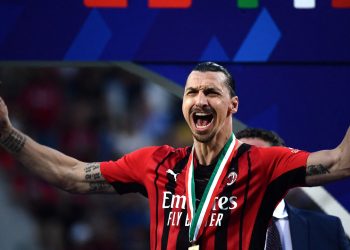 AC Milan’s Swedish forward Zlatan Ibrahimovic, holding a cigar, celebrates during the winner’s trophy ceremony after AC Milan won the Italian Serie A football match between Sassuolo and AC Milan, securing the “Scudetto” championship on May 22, 2022 at the Mapei – Citta del Tricolore stadium in Sassuolo. (Photo by Filippo MONTEFORTE / AFP)