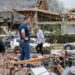 (FILES) In this file photo taken on March 31, 2023, Kris French (C) and his family search through rubble for a video recorder they think captured a direct tornado strike to their business, Champs Car Wash, after a tornado damaged hundreds of homes and buildings in Little Rock, Arkansas. – A major storm system bore down on the US east coast on April 1, 2023, after producing tornadoes and devastating winds across several central states that killed at least 11 people. Multiple tornadoes swept through Arkansas on March 31, 2023, including in the capital Little Rock, killing at least five people, the state’s governor said. Dozens of others have been reported injured. (Photo by Benjamin Krain / GETTY IMAGES NORTH AMERICA / AFP)