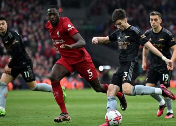 Arsenal’s Scottish defender Kieran Tierney (2R) shoots wide of the goal during the English Premier League football match between Liverpool and Arsenal at Anfield in Liverpool, north west England on April 9, 2023. (Photo by Paul ELLIS / AFP)