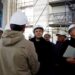 French President Emmanuel Macron (C), wearing a working helmet, talks with conservation experts as he visits the restoration site at the Notre-Dame de Paris Cathedral, which was damaged in a devastating fire four years ago, in Paris, France, April 14, 2023. (Photo by SARAH MEYSSONNIER / POOL / AFP)