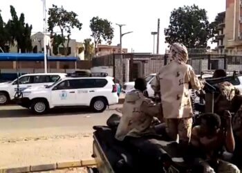 A grab taken from an AFPTV video shows a convoy leaving Khartoum towards Port Sudan, on April 23, 2023, as people flee the battle-torn Sudanese capital. (Photo by Abubakarr JALLOH / AFP)