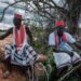 The local spiritual leaders from Kaya-Giriama ethnic group wait for the transport to visit the mass-grave site in the forest in Shakahola, outside the coastal town of Malindi, on April 24, 2023. – The death toll in a case involving a Kenyan cult that practised starvation climbed to 73 on April 24, 2023, police sources told AFP as investigators unearthed more corpses from mass graves in a forest near the coast. (Photo by Yasuyoshi CHIBA / AFP)