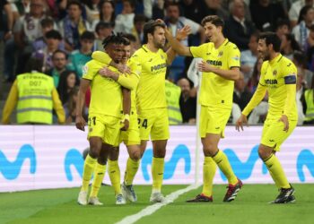 Villarreal’s Nigerian midfielder Samuel Chukwueze (L) celebrates scoring his team’s third goal during the Spanish league football match between Real Madrid CF and Villarreal CF at the Santiago Bernabeu stadium in Madrid on April 8, 2023. (Photo by Pierre-Philippe MARCOU / AFP)