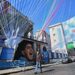 A man walks past a graffiti depicting Argentine’s football legend Diego Maradona, with flags, banners and a papier mache model of Naples’s football players (up), in the colors of Napoli, decorating the Quartieri Case Nuove in central Naples on April 29, 2023, on the eve of the Italian Serie A football match between Napoli and Salernitana. – Naples, as the city braces up for its potential first Scudetto championship win in 33 years. An incredible 19 points clear at the top of Serie A, it’s surely only a matter of time until southern Italy’s biggest club win the Scudetto for the first time since 1990, when Diego Maradona was still strutting his stuff in sight of Mount Vesuvius. (Photo by Andreas SOLARO / AFP)