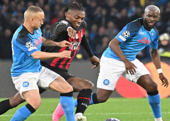 AC Milan’s Portuguese forward Rafael Leao (C) challenges Napoli’s Slovakian midfielder Stanislav Lobotka (L) and Napoli’s French midfielder Tanguy Ndombele during the UEFA Champions League quarter-finals second leg football match between SSC Napoli and AC Milan on April 18, 2023 at the Diego-Maradona stadium in Naples. (Photo by Alberto PIZZOLI / AFP)