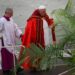 Pope Francis walks up a ramp as he arrives on the stage to preside over the celebration of the Palm Sunday mass on April 2, 2023 at St. Peter’s square in The Vatican. (Photo by Vincenzo PINTO / AFP)