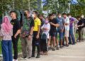 Voters wait in line to cast their ballot during advance voting at a polling station in a school in Narathiwat, southern Thailand, on May 7, 2023, a week ahead of the May 14 general election (Photo by Madaree TOHLALA / AFP)