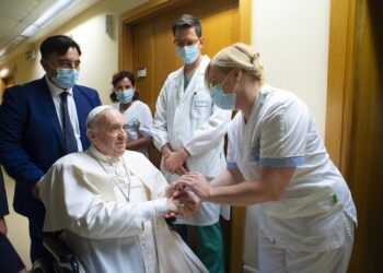 Pope Francis gives a rosary to a member of the medical staff at Gemelli hospital in Rome July 11, 2021, as he recovers following scheduled colon surgery. The pope was in the hospital for 10 days. (CNS photo/Vatican Media via Reuters)