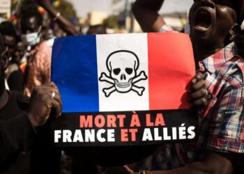 Demonstrators hold up a that reads, “Death to France and its allies”, during a mass demonstration, in Bamako, January 14, 2022. (AFP)