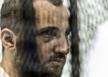 Egyptian Mohamed Adel (L) is pictured during his first trial session at the Mansoura courthouse in Cairo, June 26, 2022. (AFP)