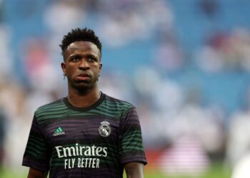 (FILES) Real Madrid’s Brazilian forward Vinicius Junior warms up prior to the Spanish league football match between Real Madrid CF and Athletic Club Bilbao at the Santiago Bernabeu stadium in Madrid on June 4, 2023. – Rio de Janeiro’s legislative assembly on June 6, 2023, approved a bill that provides for the interruption or suspension of football matches in cases of racism, in the first concrete action in Brazil following the wave of outrage over racist behaviour towards Brazilian Vinicius Jr. in Spain. (Photo by Pierre-Philippe MARCOU / AFP)