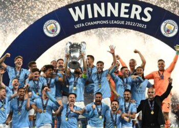 Manchester City’s German midfielder #8 Ilkay Gundogan holds aloft the European Cup trophy as they celebrate winning the UEFA Champions League final football match between Inter Milan and Manchester City at the Ataturk Olympic Stadium in Istanbul, on June 10, 2023. – Manchester City won the match 1-0. (Photo by Paul ELLIS / AFP)