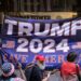 Supporters of former US President Donald Trump raise a flag during a demonstration outside of Trump Tower in New York City on June 13, 2023. – Former US President and 2024 Presidential hopeful Donald Trump is appearing in court in Miami for an arraignment regarding 37 federal charges, including violations of the Espionage Act, making false statements, and conspiracy regarding his mishandling of classified material after leaving office. (Photo by Yuki IWAMURA / AFP)