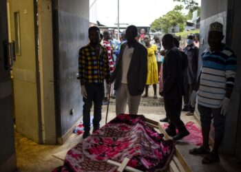 Relatives of victims of the Mpondwe Lhubiriha Secondary School gather at the Bwera General Hospital Mortuary, Kasese, on June 18, 2023. – Distraught families gathered at a mortuary in western Uganda on Sunday for any news of their loved ones after a militant attack left dozens of students dead and others missing.Officials say at least 41 people, mostly students, were massacred at a secondary school near the border of the Democratic Republic of Congo late Friday by militants linked to the Islamic State group. (Photo by Stuart Tibaweswa / AFP)